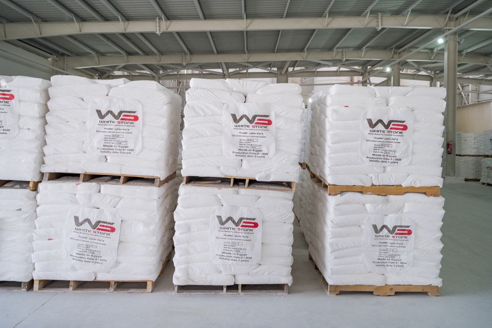 Palletized White Stone branded 25 kg bags of calcium carbonate stacked in the dispatch warehouse