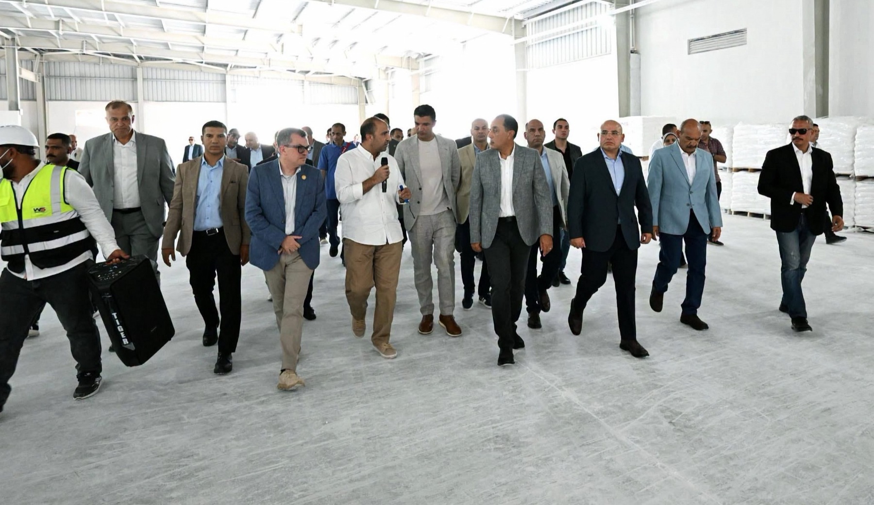 The Prime Minister and delegation walking the White Stone finished-goods warehouse