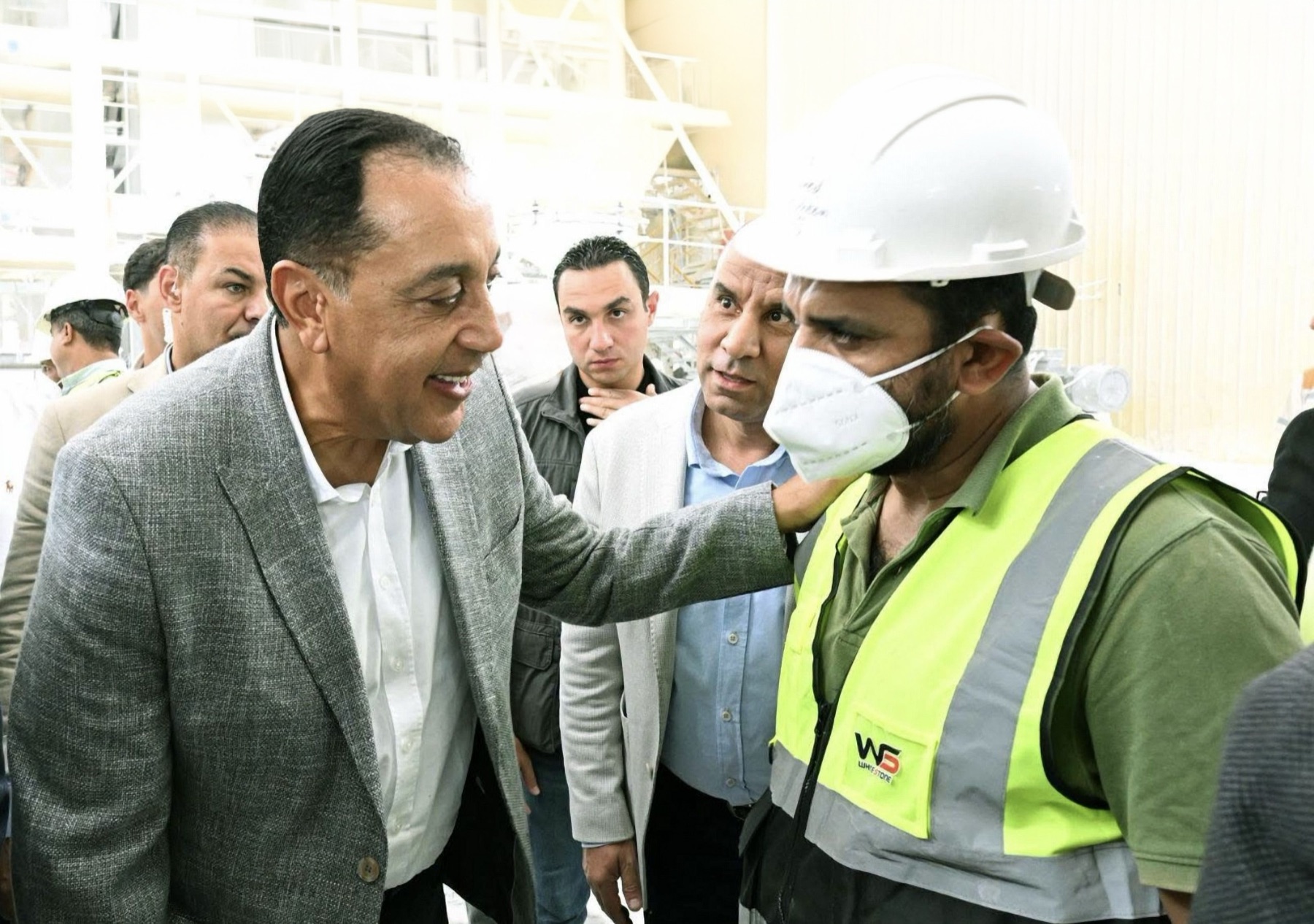 The Prime Minister greeting a White Stone operator on the plant floor