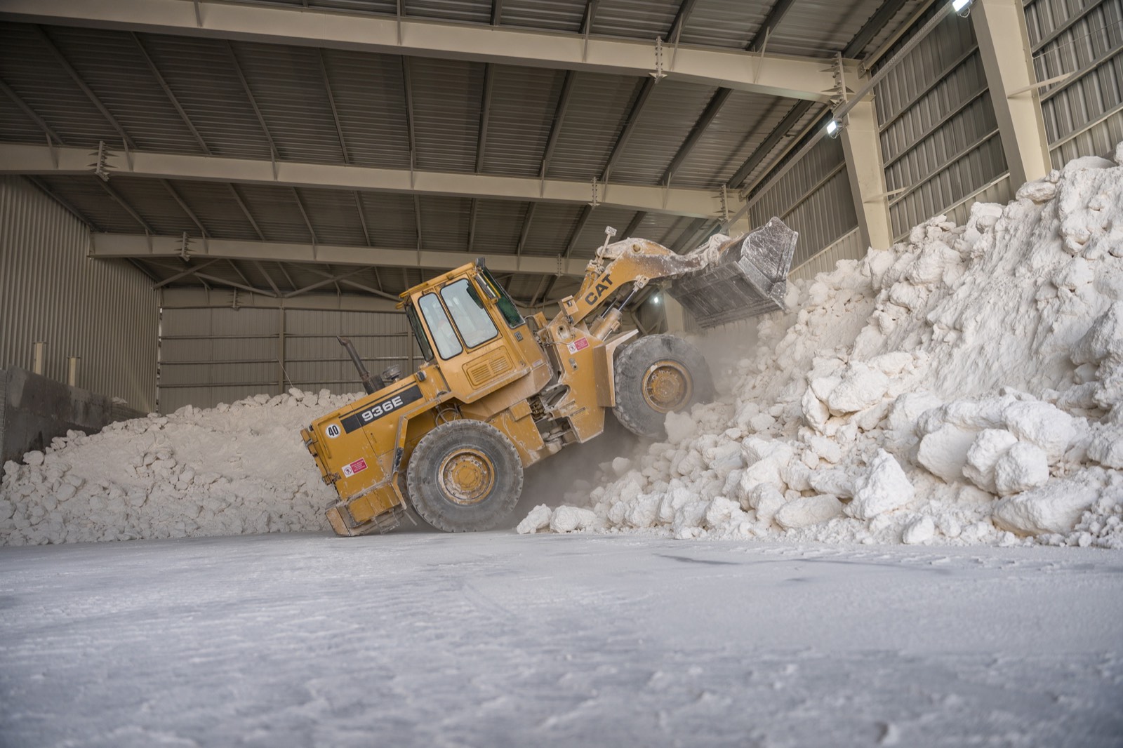 Wheel loader working the white limestone stockpile in the covered raw material store